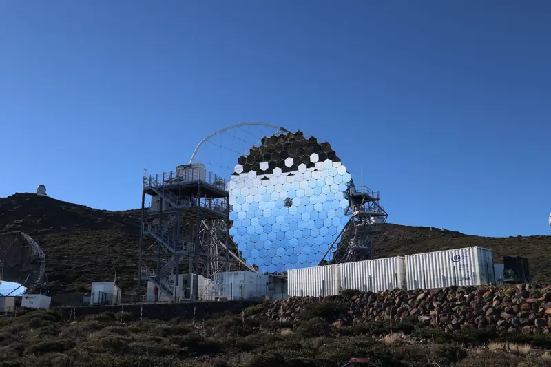 Modern telescope in La Palma set against a clear blue sky, a prime travel destination for stargazing