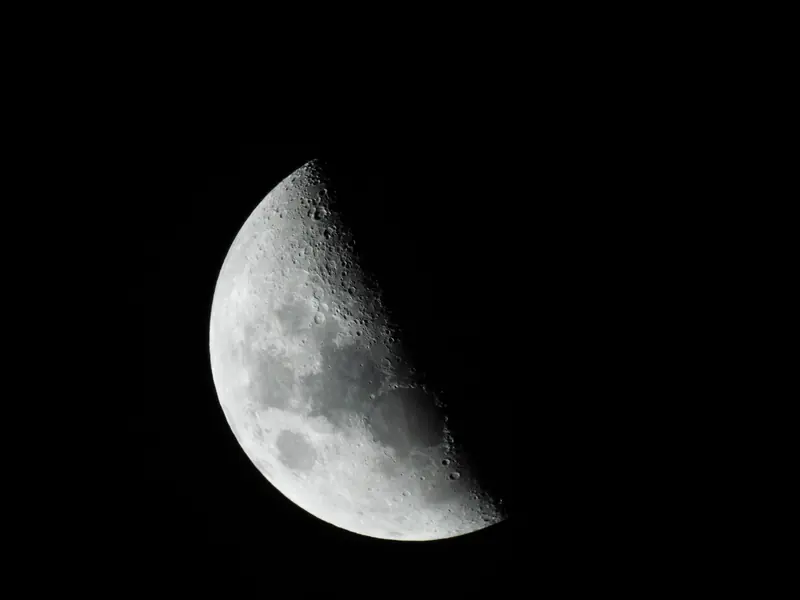 Close-up of the moon in black and white, showcasing its craters and texture