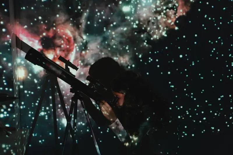 A girl looks through a telescope at a starry projection, blending education with wonder