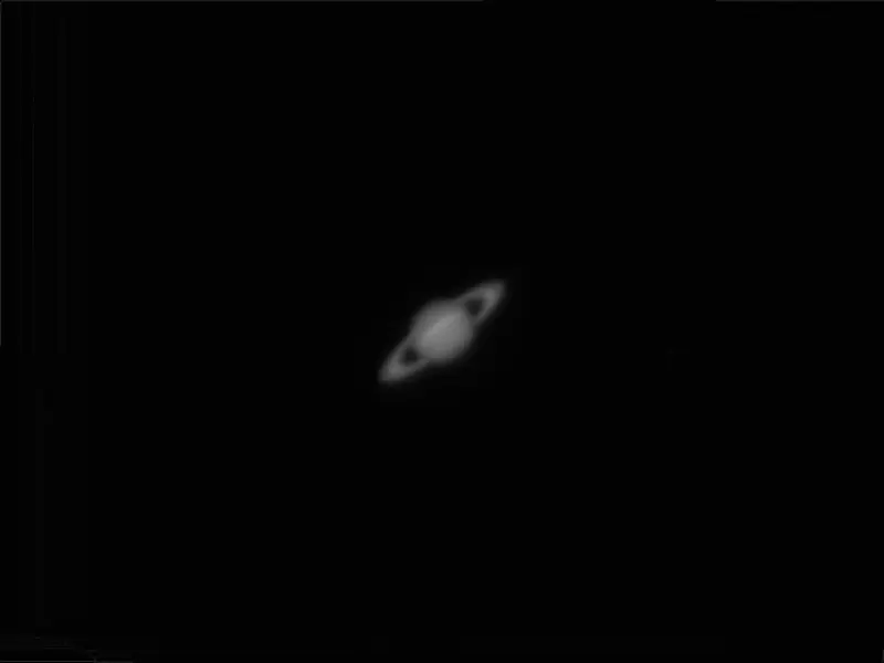 A captivating black and white photograph of Saturn showcasing its iconic rings